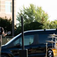 Jesse Ray and the Carolina Catfish band playing guitar and drums.